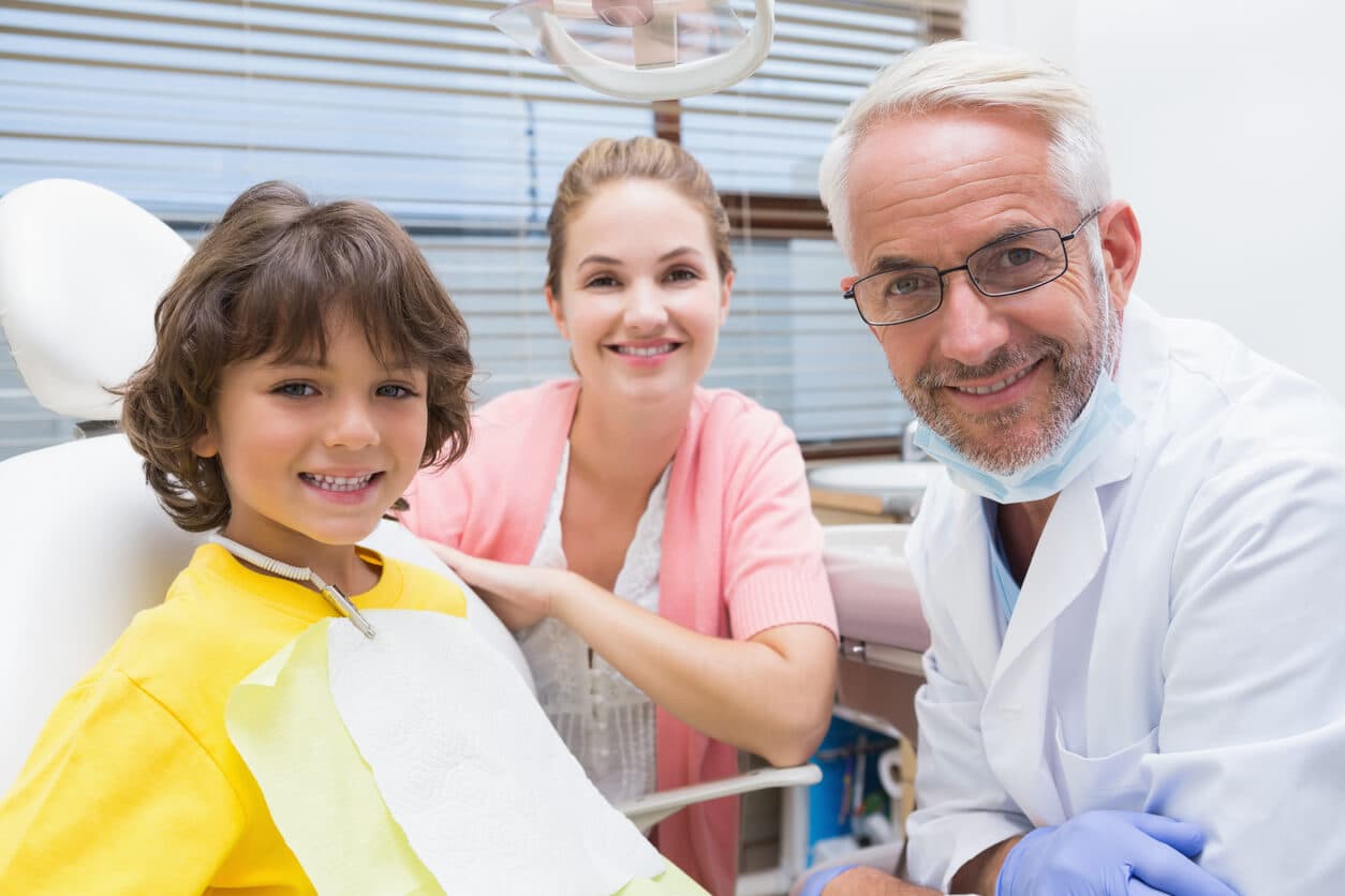 Child and dentist smiling