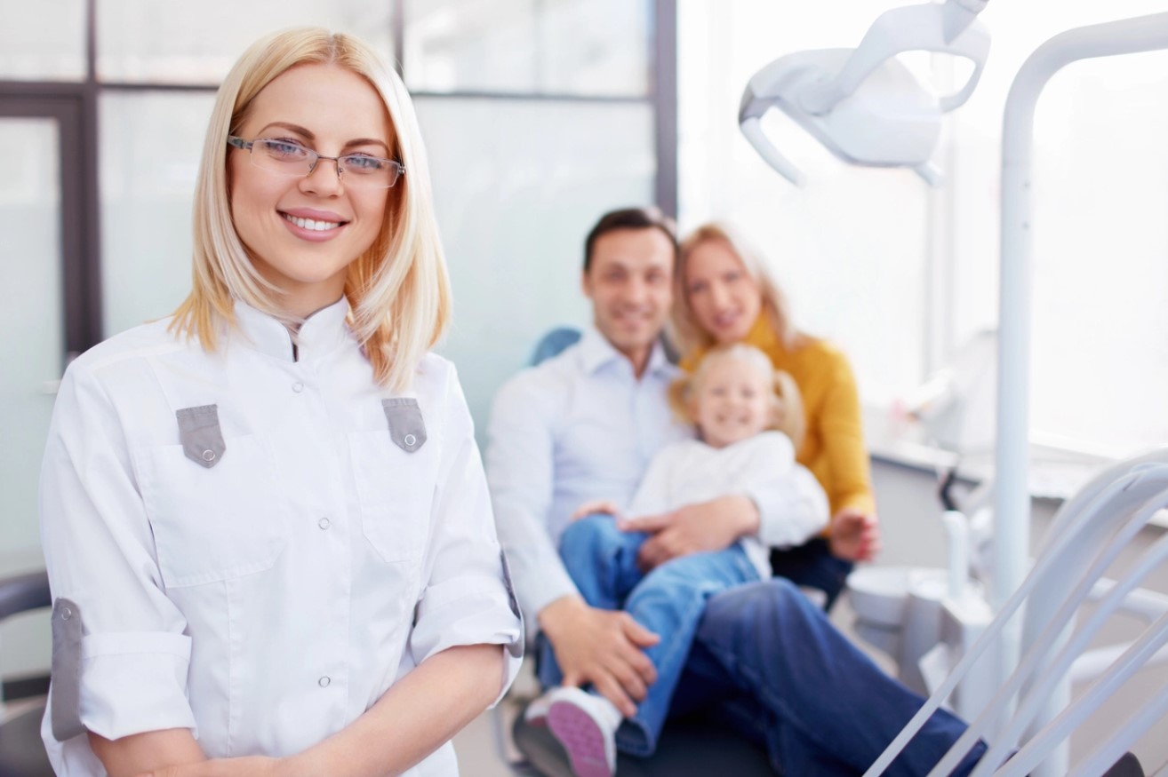 dentist with happy family